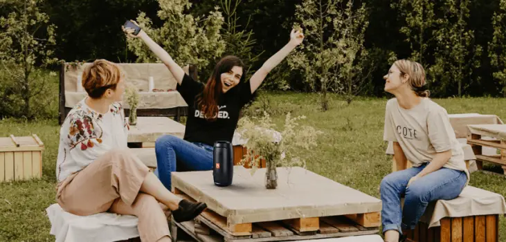 image of 3 women listening to music in the backyard